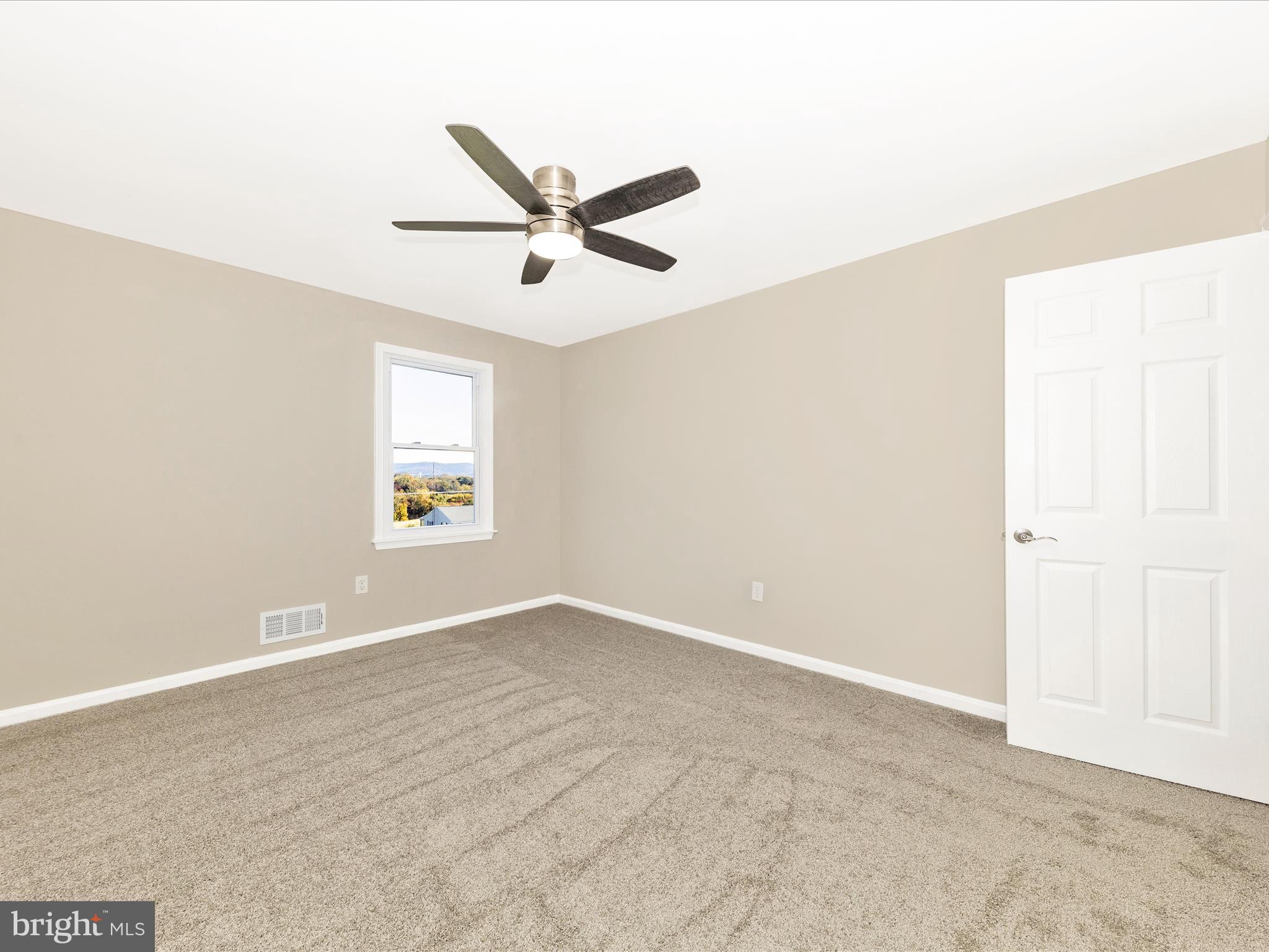 2431 Quebec School Road Middletown, MD 21769 - Photo 35 of 56 an empty room with a window and a fan