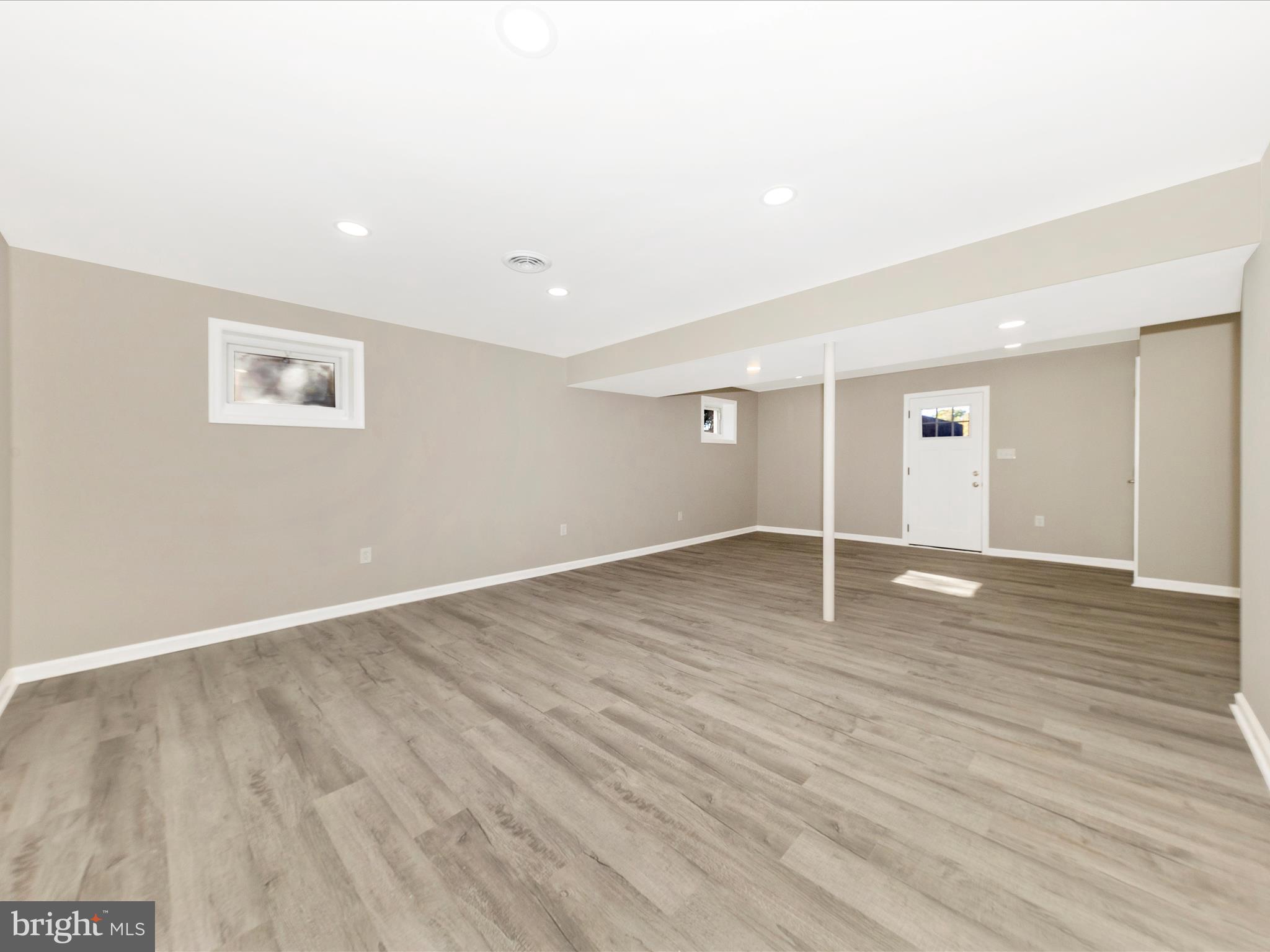 2431 Quebec School Road Middletown, MD 21769 - Photo 39 of 56 an empty room with wooden floor and windows