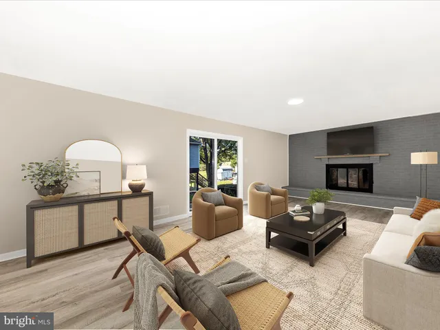 a living room with furniture a fireplace and a potted plant