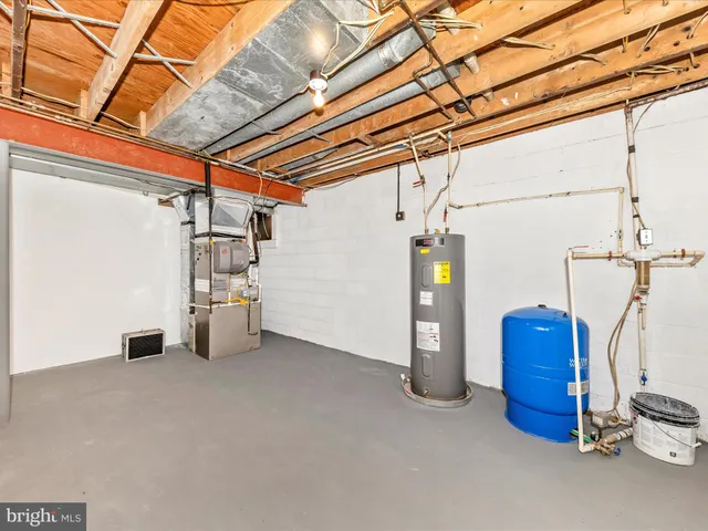 a view of a house with a yard and large tree