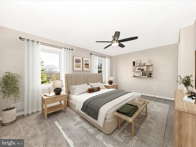 a bedroom with a large bed couch and a window