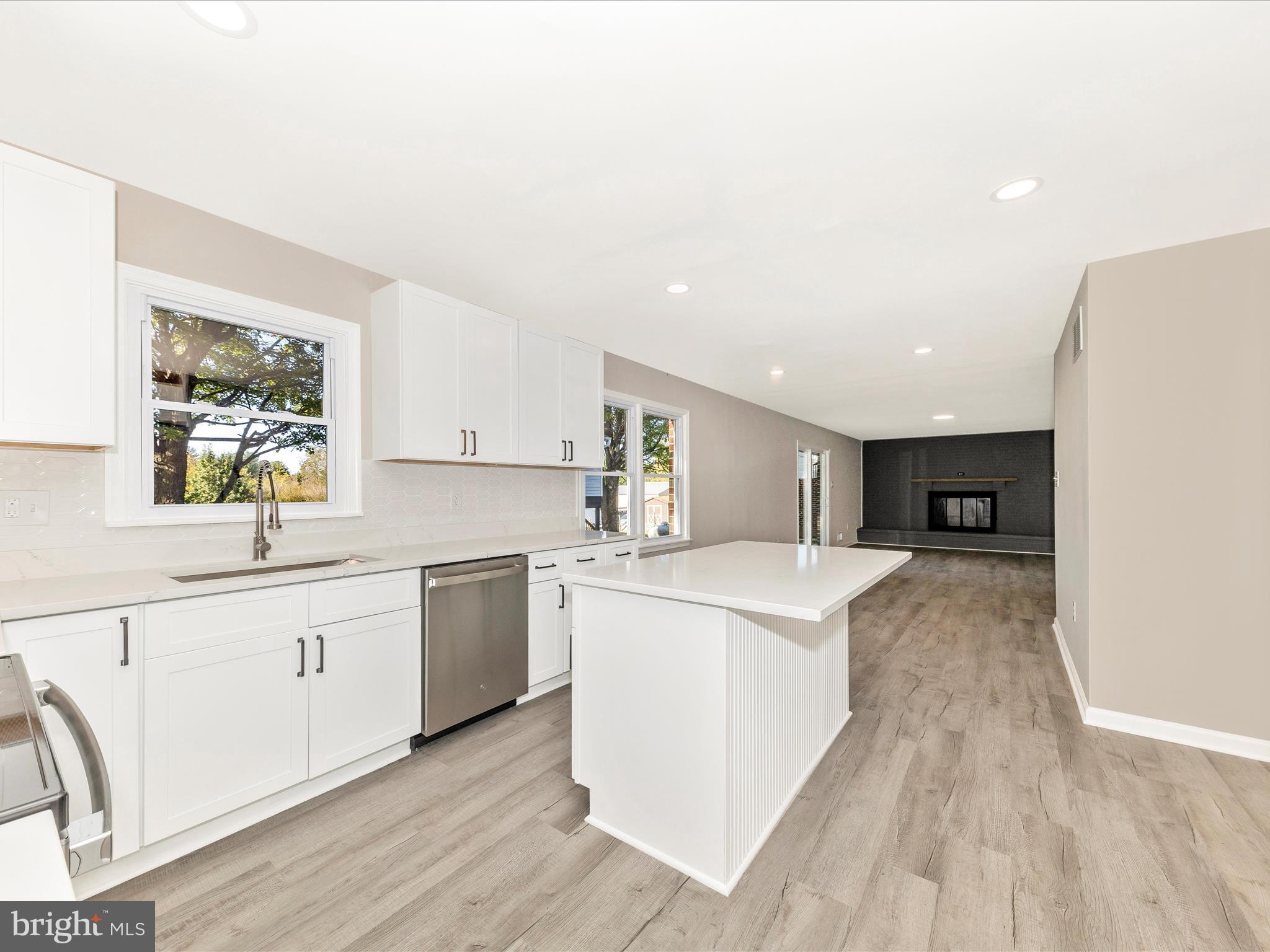 2431 Quebec School Road Middletown, MD 21769 - Photo 7 of 56 a large kitchen with stainless steel appliances granite countertop a stove a sink a refrigerator and white cabinets with wooden floor