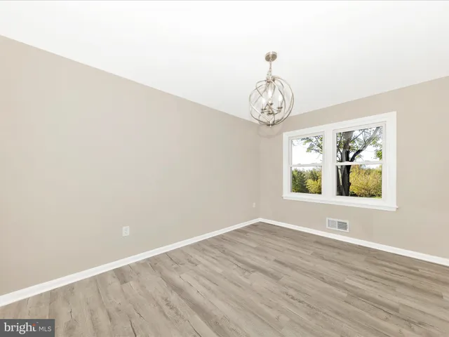 a view of room with wooden floor and window
