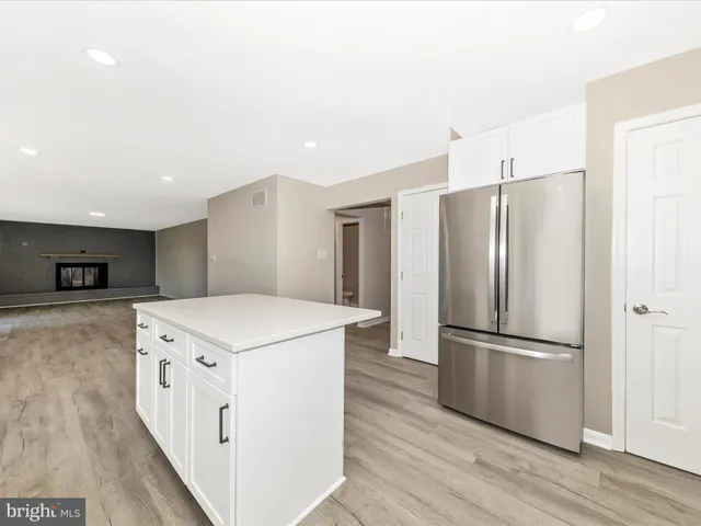 a kitchen with stainless steel appliances a refrigerator and a stove top oven