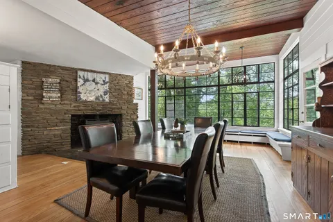 a dining room with furniture a chandelier and wooden floor