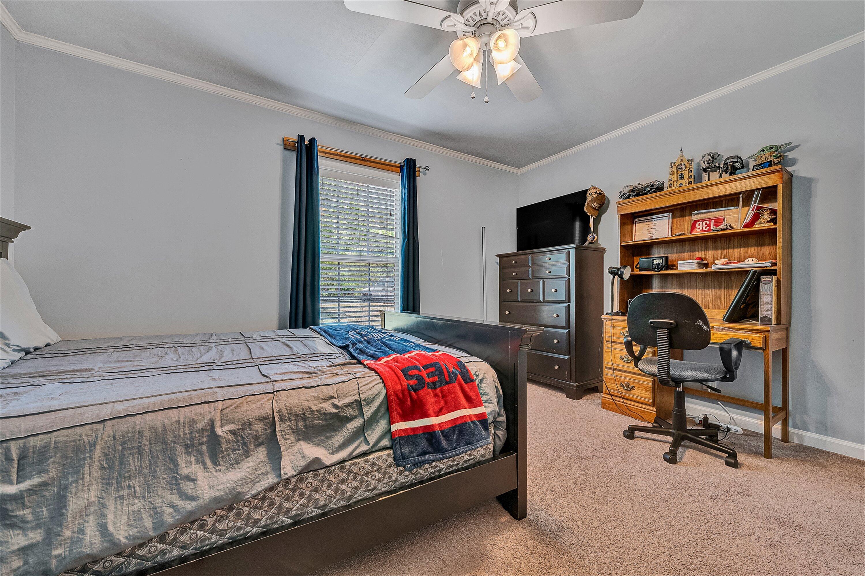 159 Simmons Creek Road Union Hall, VA 24176 - Photo 29 of 55 a bedroom with a bed and a chandelier