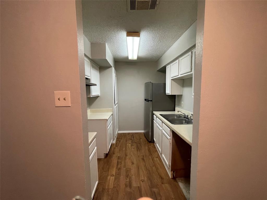 9696 Walnut Street, Unit 1413 Dallas, TX 75243 - Photo 11 of 17 a kitchen with a sink a stove top oven and cabinets