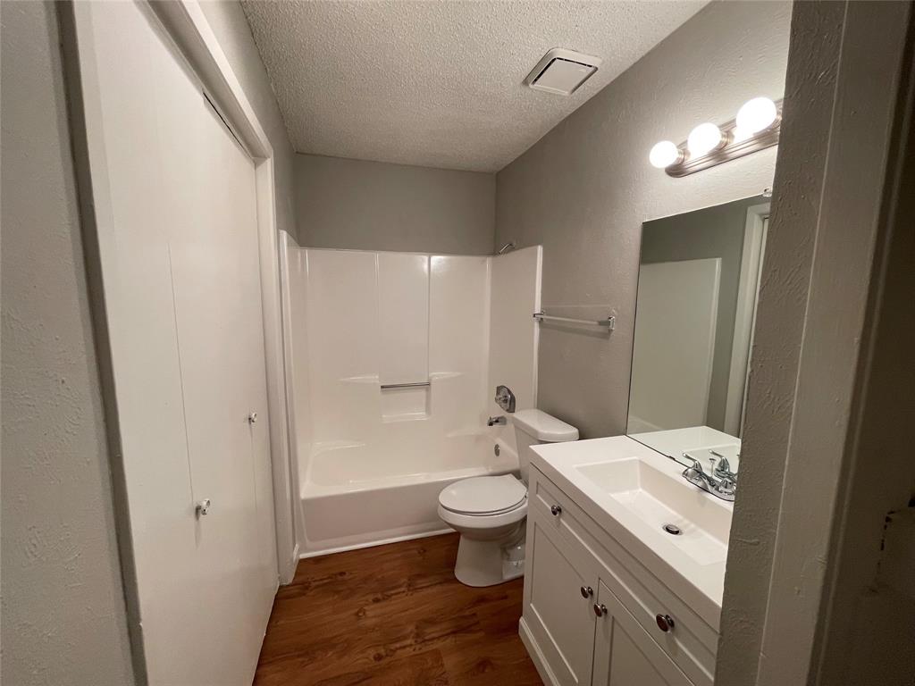 9696 Walnut Street, Unit 1413 Dallas, TX 75243 - Photo 16 of 17 a bathroom with a sink a toilet and shower