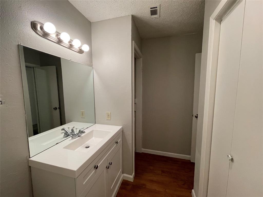 9696 Walnut Street, Unit 1413 Dallas, TX 75243 - Photo 17 of 17 a bathroom with a sink and a mirror