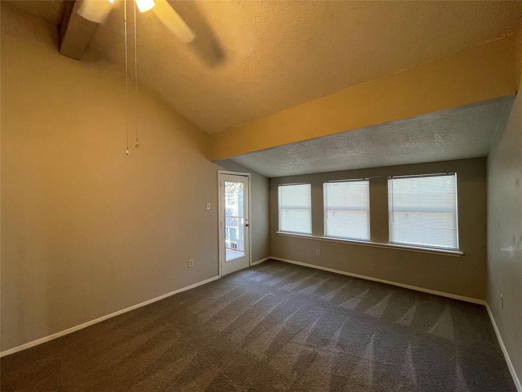 9696 Walnut Street, Unit 1413 Dallas, TX 75243 - Photo 3 of 17 an empty room with wooden floor and windows