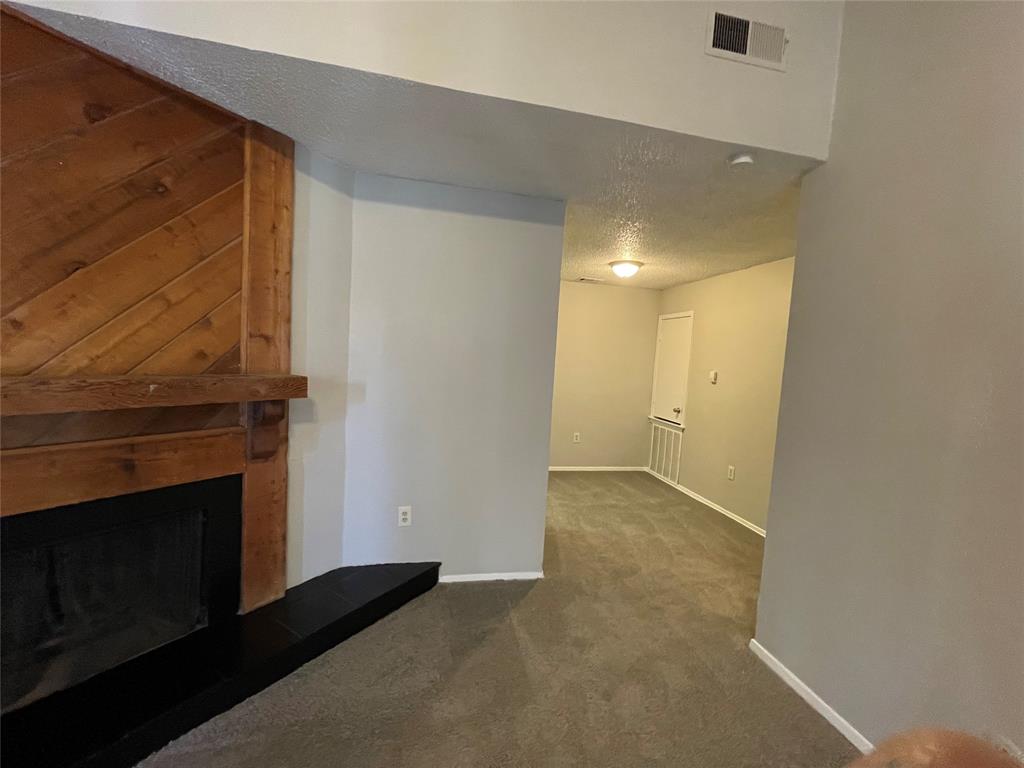 9696 Walnut Street, Unit 1413 Dallas, TX 75243 - Photo 5 of 17 a view of empty room with wooden floor and fireplace