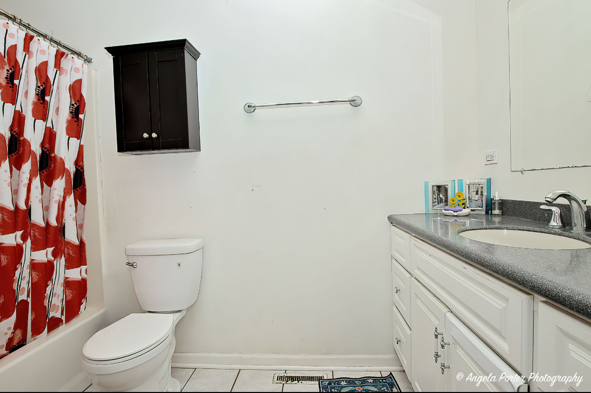 19212 Crowley Road Harvard, IL 60033 - Photo 18 of 38 a bathroom with a granite countertop toilet sink and mirror