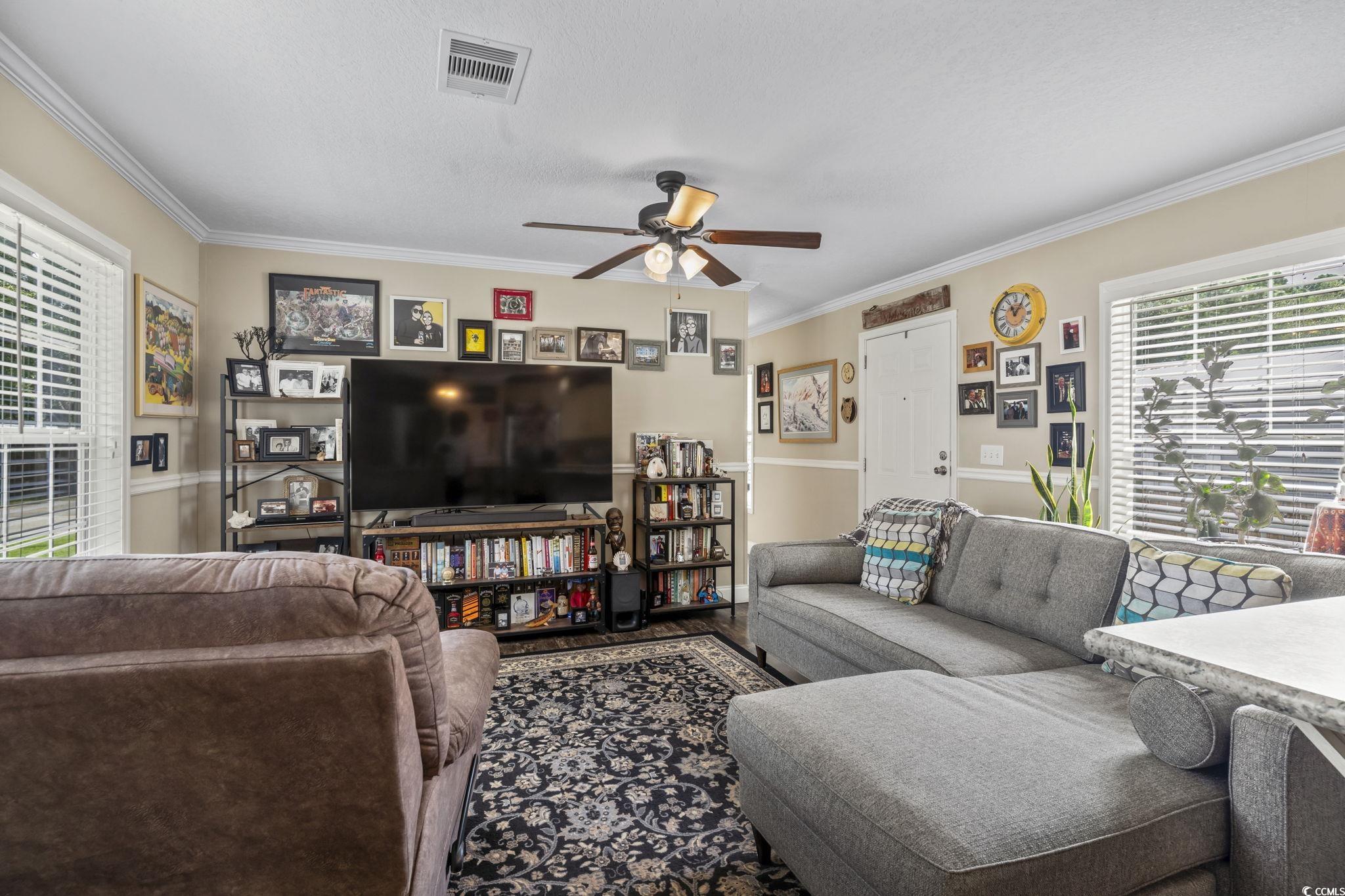 79 Offshore Drive Murrells Inlet, SC 29576 - Photo 3 of 31 Living room with ornamental molding, ceiling fan, wood finished floors, and a textured ceiling