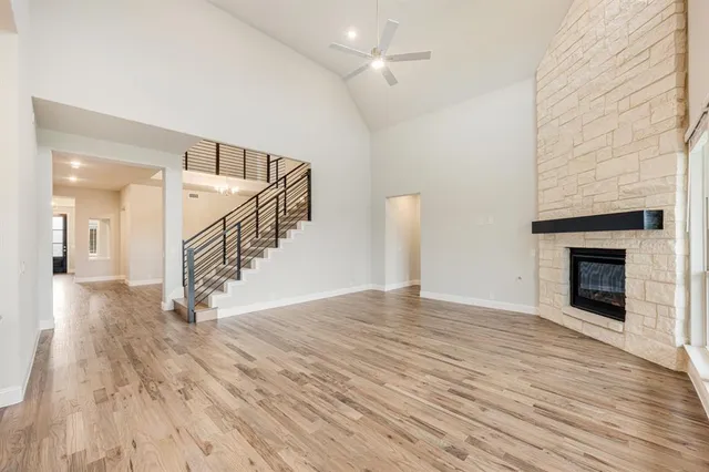 a view of empty room with wooden floor and fireplace