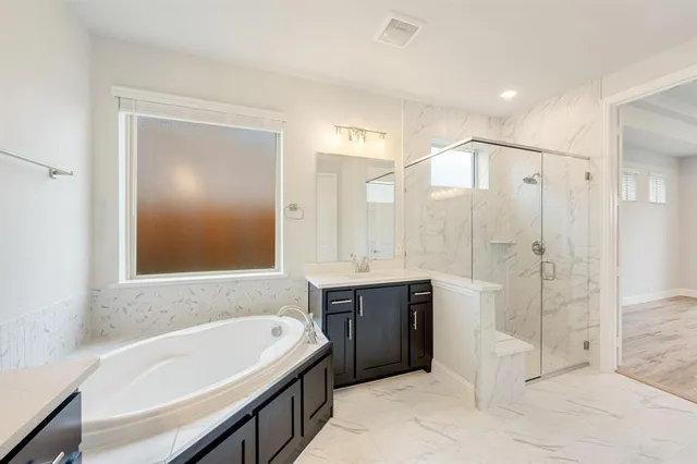 a bathroom with a bathtub and a sink