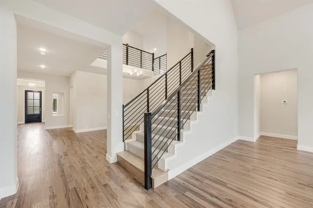 a view of entryway and hall with wooden floor