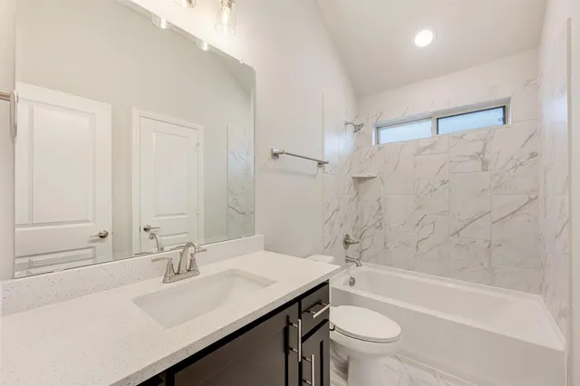 an empty room with a window and a ceiling fan