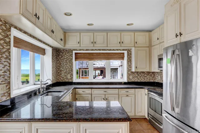 a kitchen with stainless steel appliances granite countertop a stove and a sink