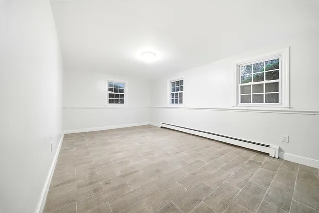 a spacious bathroom with a shower sink and mirror