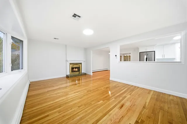 a view of an empty room with a fireplace