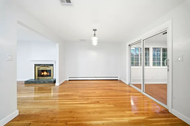 a view of a kitchen with wooden floor and a kitchen