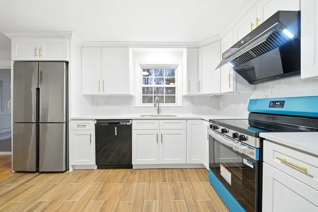a kitchen with granite countertop cabinets stainless steel appliances and a window