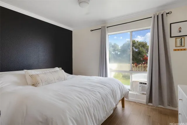 a bedroom with a large bed and a window