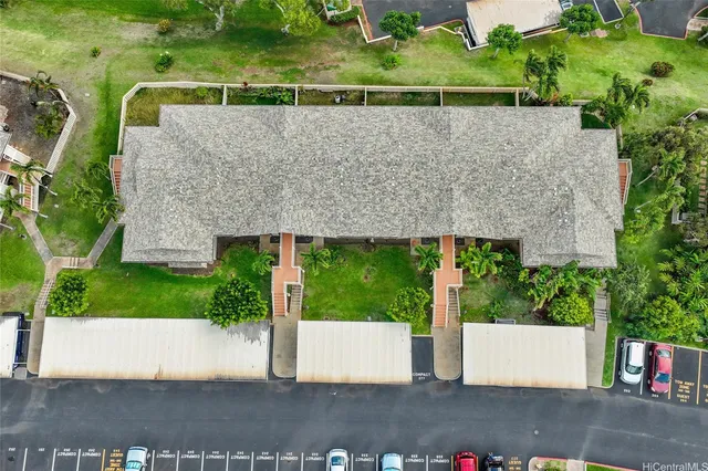 an aerial view of a house with a garden and yard
