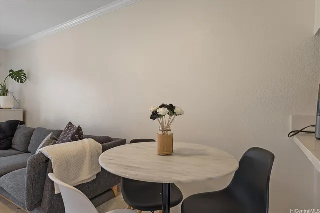 a dining room with furniture and a potted plant