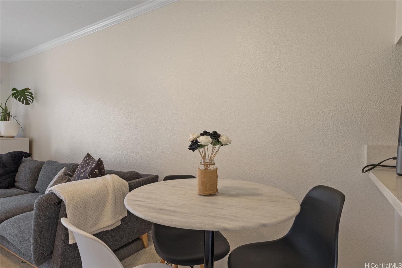 92-1232 Palahia Street, Unit AA102 Kapolei, HI 96707 - Photo 4 of 25 a dining room with furniture and a potted plant