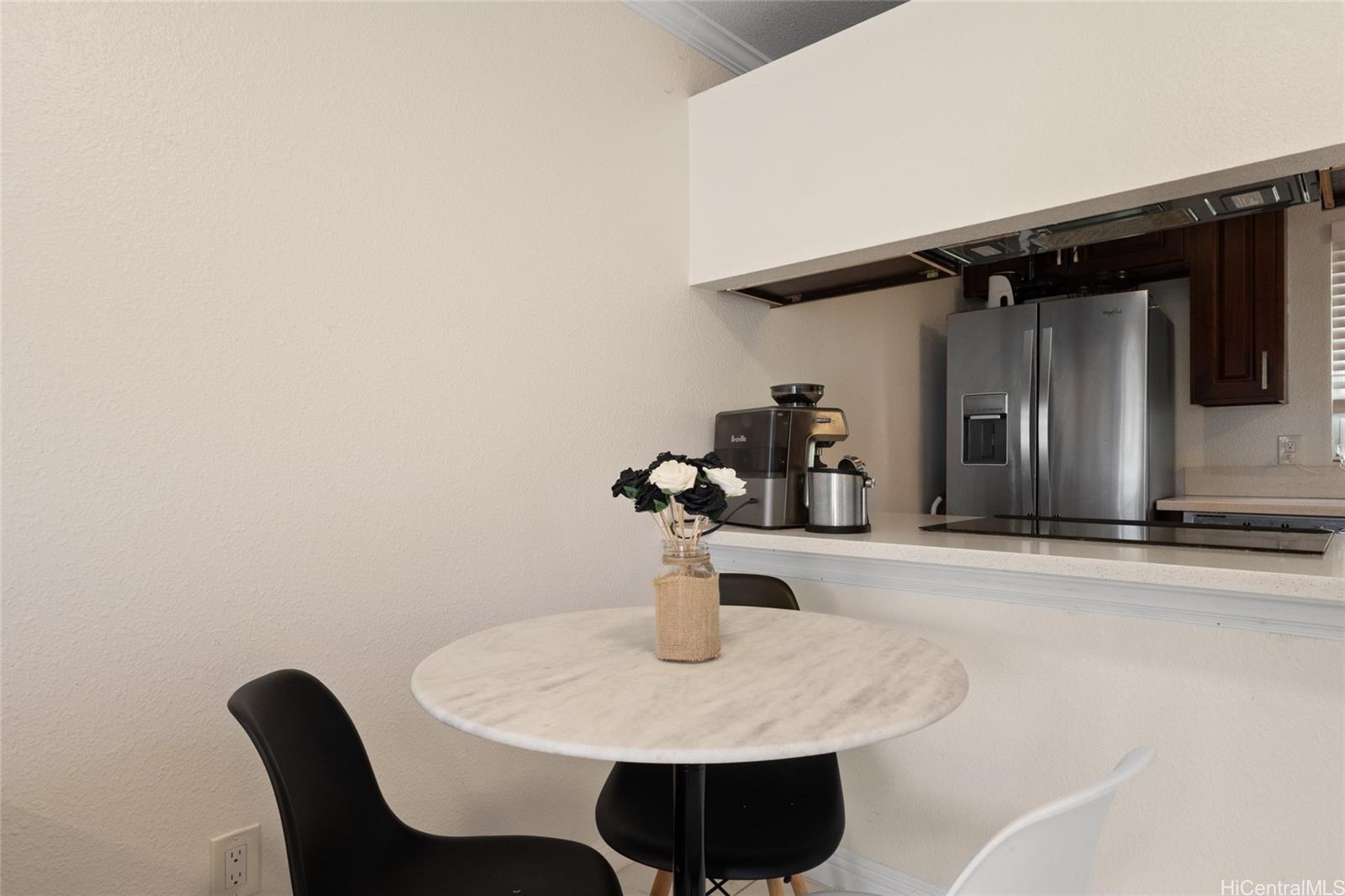 92-1232 Palahia Street, Unit AA102 Kapolei, HI 96707 - Photo 5 of 25 a kitchen with a table and chairs