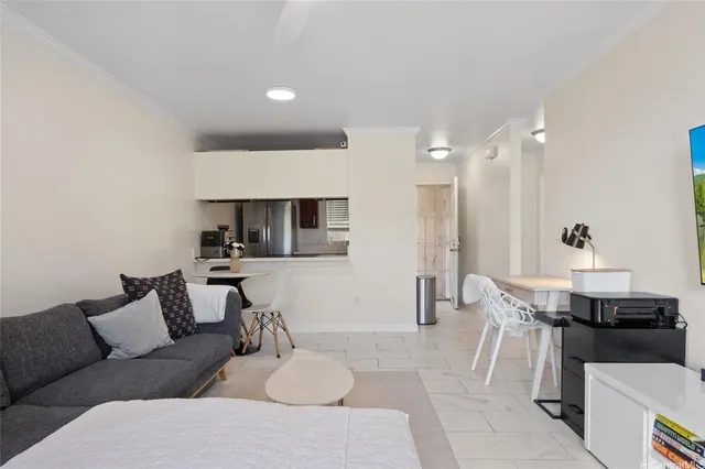 a living room with furniture and kitchen view