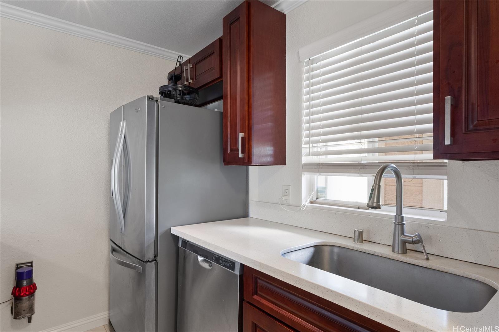 92-1232 Palahia Street, Unit AA102 Kapolei, HI 96707 - Photo 9 of 25 a kitchen with a refrigerator and a sink