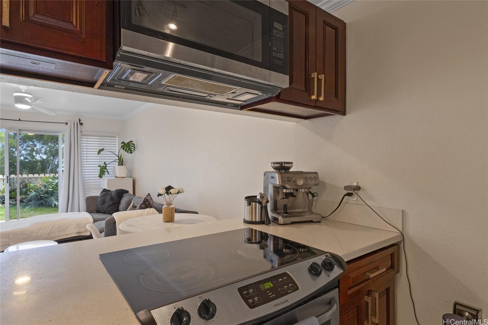 92-1232 Palahia Street, Unit AA102 Kapolei, HI 96707 - Photo 10 of 25 a kitchen with a stove and a microwave