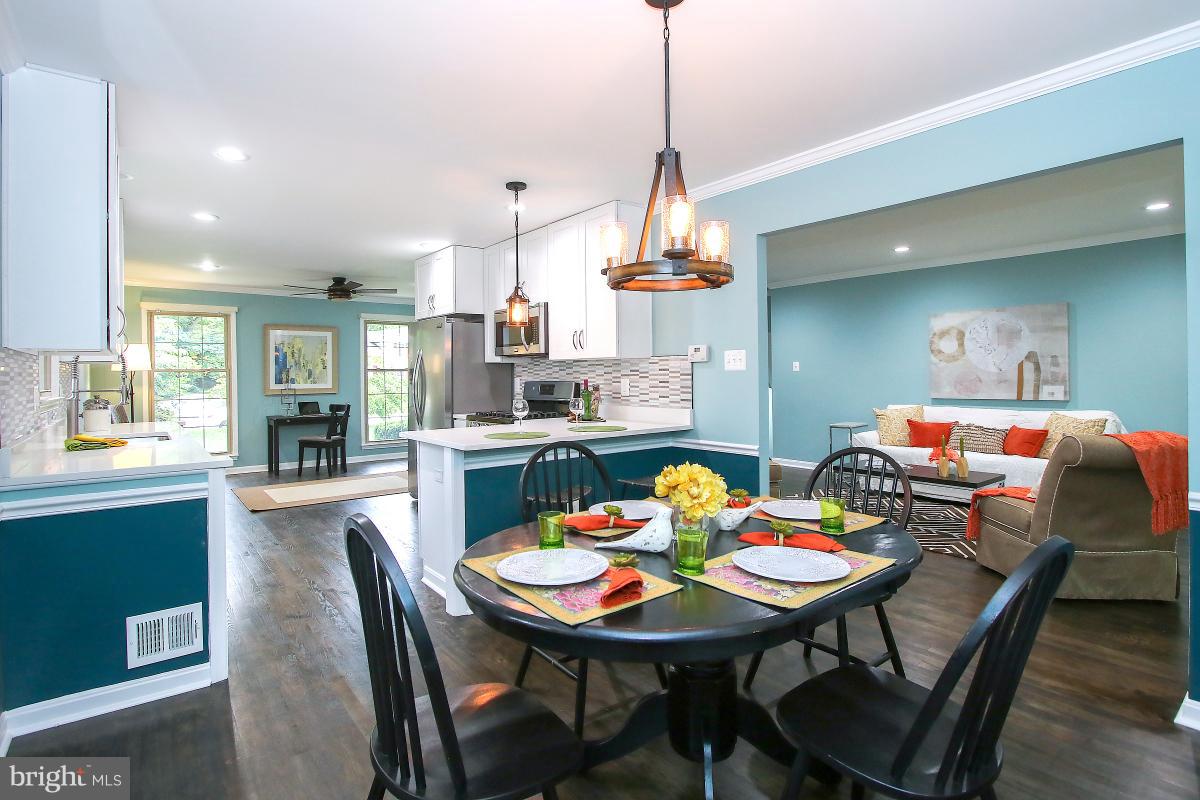 13121 Tamarack Road Silver Spring, MD 20904 - Photo 1 of 30 a view of a dining room and livingroom with furniture wooden floor a chandelier