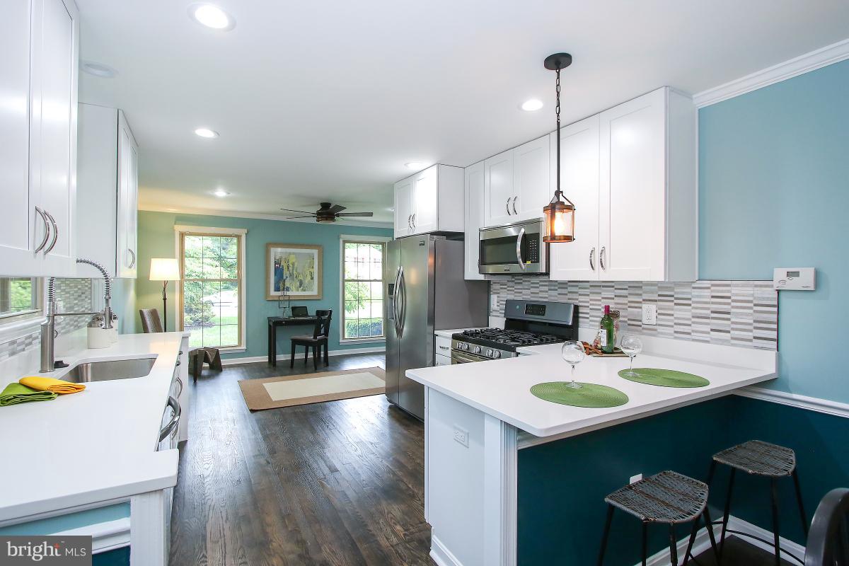 13121 Tamarack Road Silver Spring, MD 20904 - Photo 14 of 30 a kitchen with sink stove and chairs