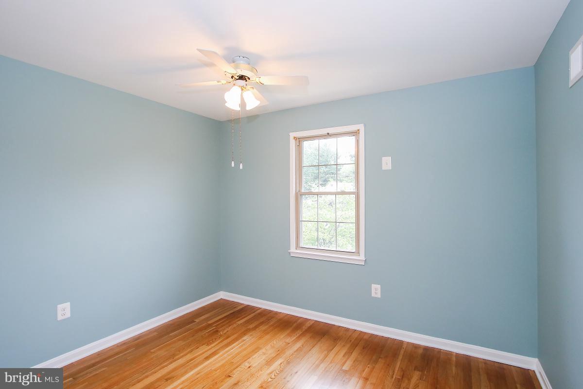 13121 Tamarack Road Silver Spring, MD 20904 - Photo 17 of 30 wooden floor in an empty room with a window