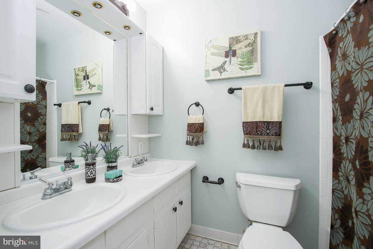 13121 Tamarack Road Silver Spring, MD 20904 - Photo 19 of 30 a bathroom with a toilet sink and mirror