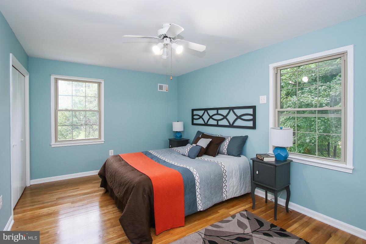 13121 Tamarack Road Silver Spring, MD 20904 - Photo 20 of 30 a bedroom with a bed and a lamp on table
