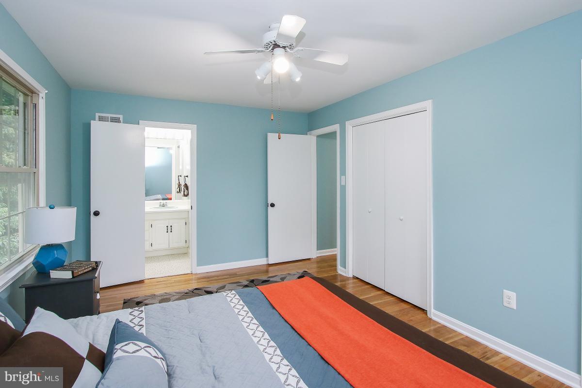 13121 Tamarack Road Silver Spring, MD 20904 - Photo 22 of 30 a bedroom with a bed and a chandelier