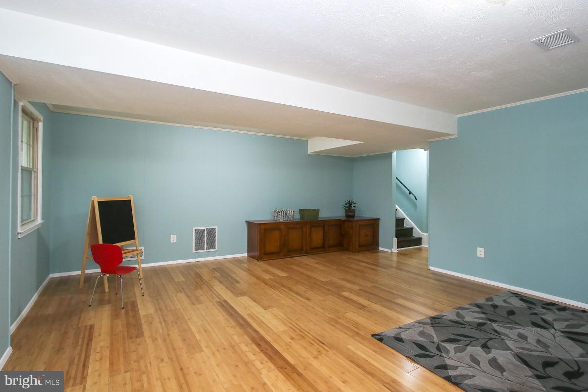 13121 Tamarack Road Silver Spring, MD 20904 - Photo 26 of 30 a bedroom with a bed and wooden floor
