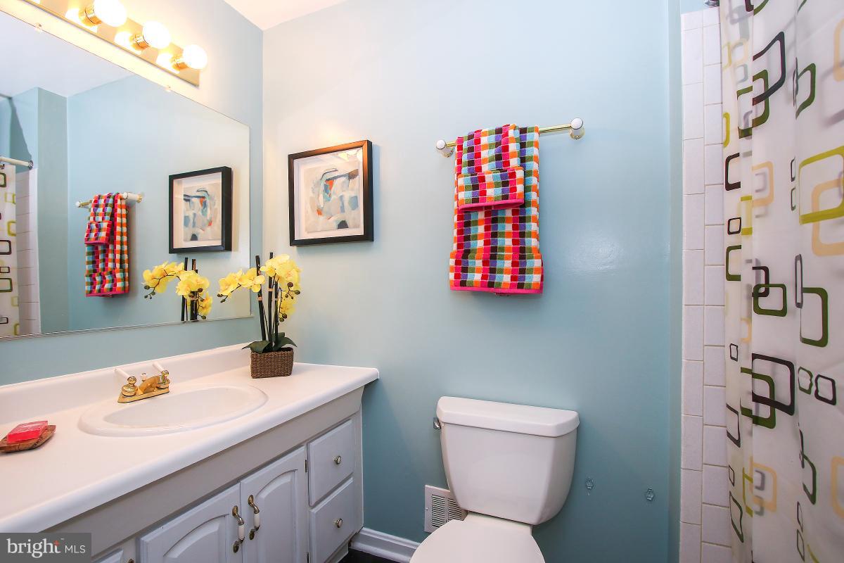 13121 Tamarack Road Silver Spring, MD 20904 - Photo 28 of 30 a bathroom with a sink toilet and a mirror