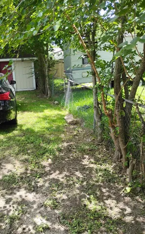 a backyard of a house with a table and chairs