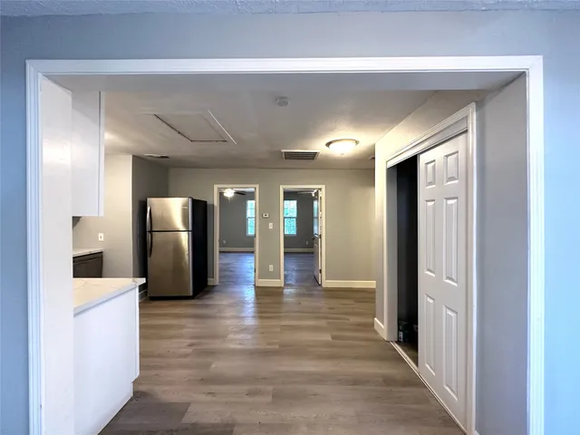 a view of a hallway view with wooden floor and staircase