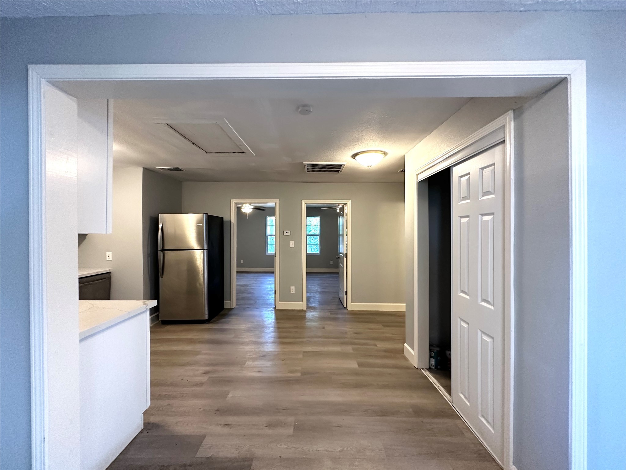 4318 1st Street, Unit B Bacliff, TX 77518 - Photo 3 of 21 a view of a hallway view with wooden floor and staircase
