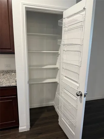 a view of walk in closet with empty racks
