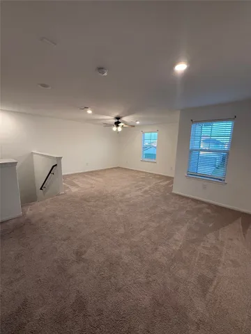 an empty room with windows and closet