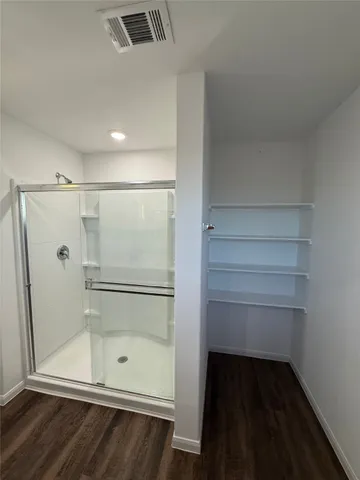 a bathroom with a glass shower door