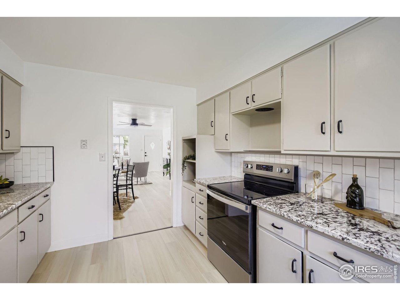 604 Colorado Street Fort Collins, CO 80524 - Photo 13 of 32 a kitchen with granite countertop a stove and a sink