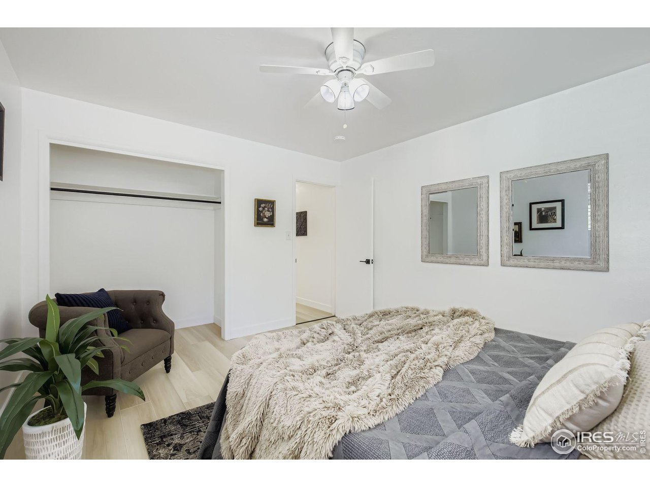 604 Colorado Street Fort Collins, CO 80524 - Photo 17 of 32 a bedroom with a bed and a chandelier